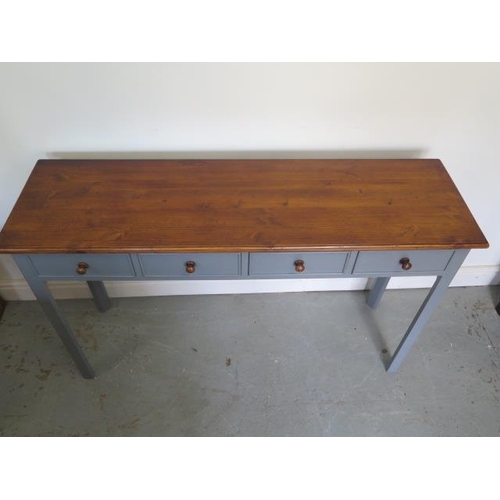 505 - A painted four drawer hall/side table with a polished distressed pine top - made by a local craftsma... 