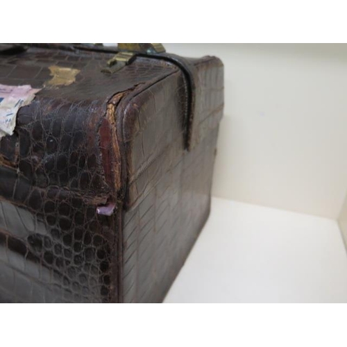 260 - An early 20th century crocodile travel case by Finnigan makers with a fitted interior including seve... 
