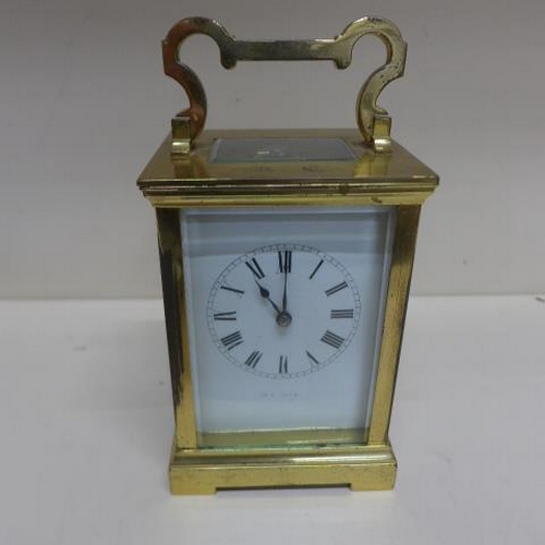 258 - A French carriage clock - Height 14cm with handle down - running, with key