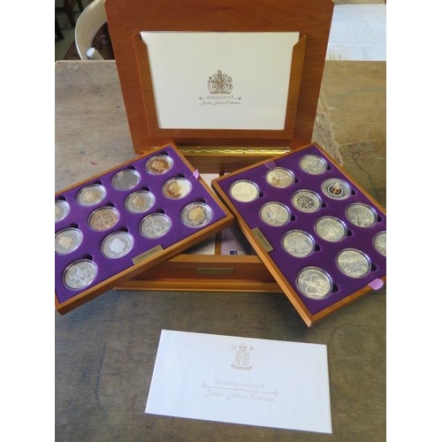 245 - A Royal Mint Queen Elizabeth II Golden Jubilee collection - 24 silver coins in a wood effect present... 