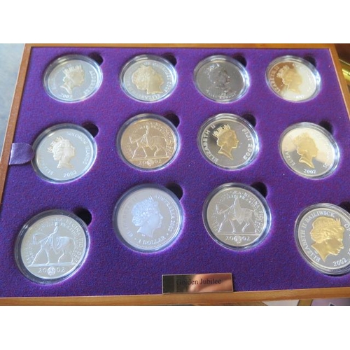 245 - A Royal Mint Queen Elizabeth II Golden Jubilee collection - 24 silver coins in a wood effect present... 