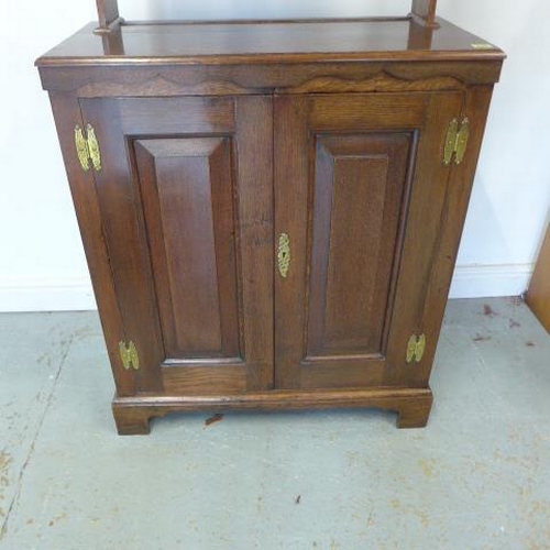 527 - An oak two door panelled cupboard with an open rack top, nice polished colour - Height 166cm x 77cm ... 