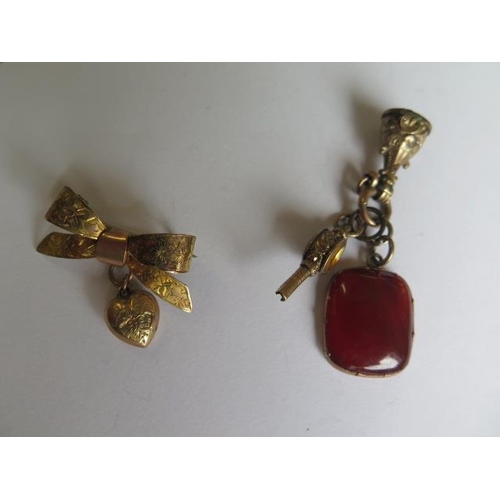 102 - A gilt metal pin brooch, gilt metal Chinese pendant, gilt metal fobs and watch key and a gilt metal ... 