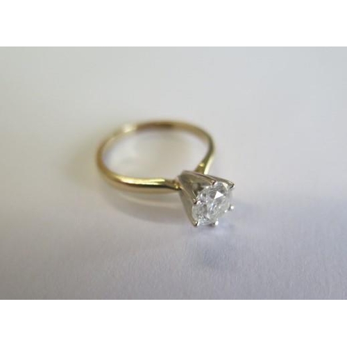 105 - A yellow gold and white metal diamond solitaire ring with a round brilliant cut diamond approx weigh... 