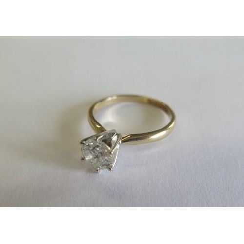 105 - A yellow gold and white metal diamond solitaire ring with a round brilliant cut diamond approx weigh... 