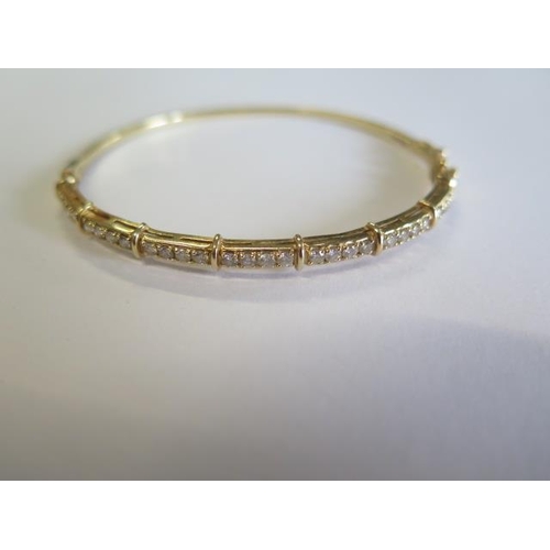 113 - A 14ct yellow gold diamond hinged bangle - 5.5cm x 6.5cm external, approx weight 9.4 grams and a 9ct... 