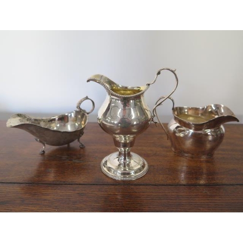 164 - A silver sauceboat, silver cream jug and a silver milk jug - total approx weight 8.9 troy oz - engra... 