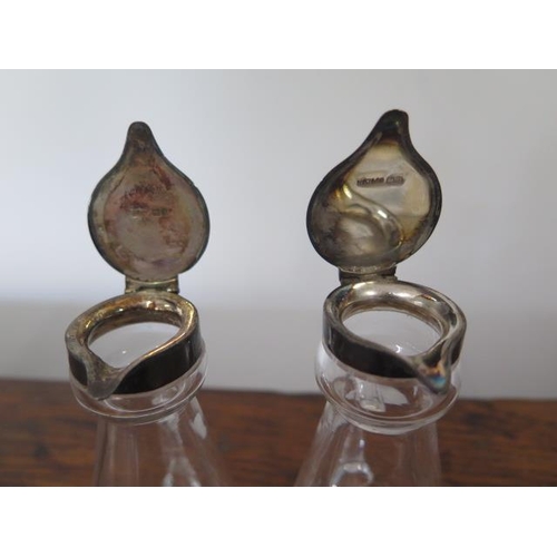 168 - A near pair of silver top cut glass whisky noggins Birmingham hallmarks, one Mappin and Webb - 10cm ... 
