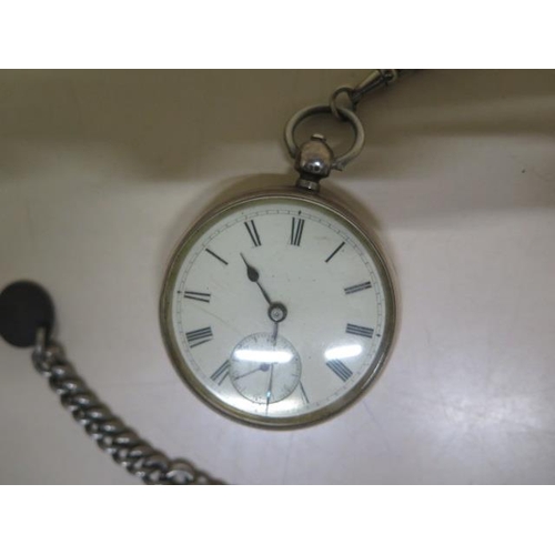 205 - A silver key wind pocket watch with chain - crack to dial but running - 50mm case - with key