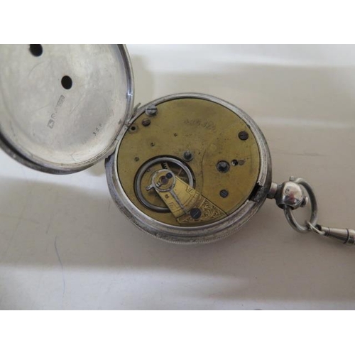 205 - A silver key wind pocket watch with chain - crack to dial but running - 50mm case - with key