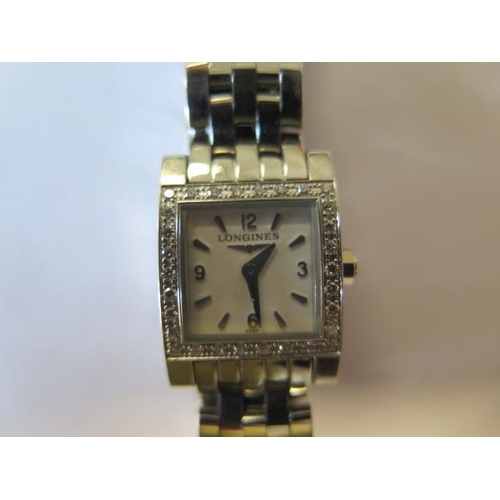 209 - A ladies Longines wristwatch - rectangular white brushed dial, silver coloured Arabic numerals at 12... 