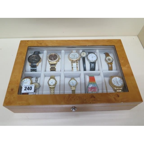 240 - A collection of 12 assorted watches in an Axis show case