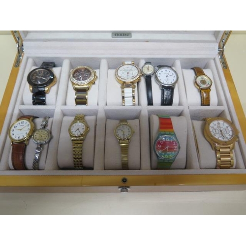 240 - A collection of 12 assorted watches in an Axis show case