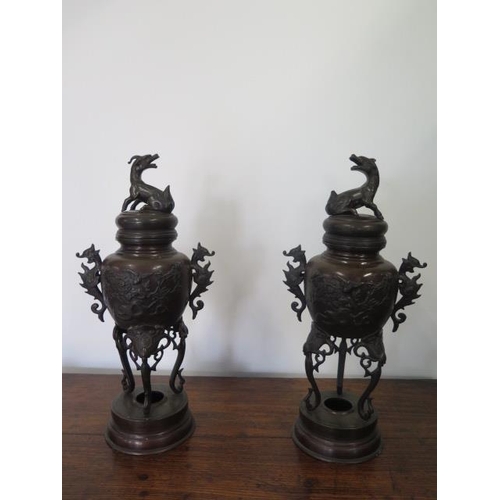 295 - A pair of Oriental bronze lidded censors on stands - Height 41cm - both with good patina