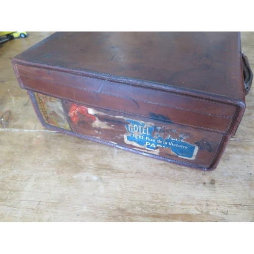 303 - A vintage leather suitcase with interesting travel stickers - 17cm x 51cm x 38cm - with good colour,... 