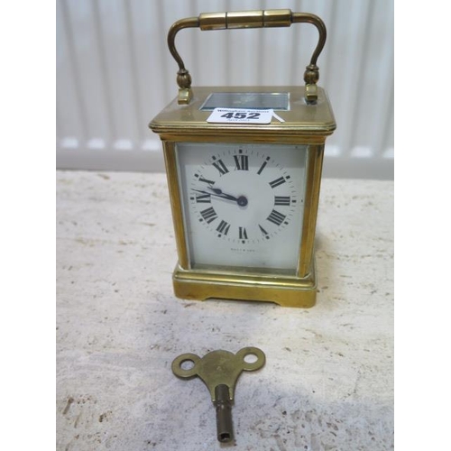 452 - A brass carriage clock the dial signed Ross & Son - working with key