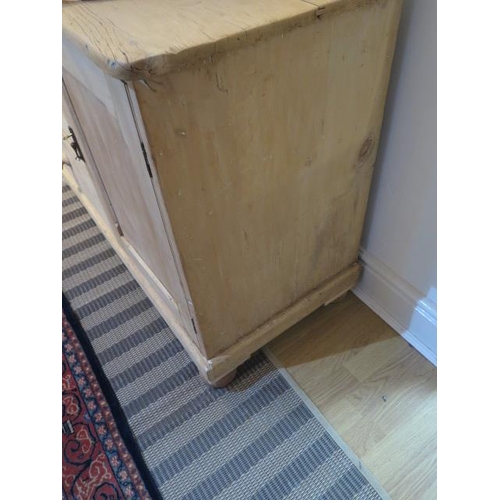 483 - A stripped pine Victorian dresser base with three drawers and a cupboard door  Height 85cm x 122cm x... 