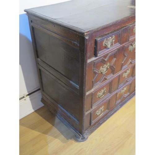 484 - An 18th century oak chest with four geometric drawers raised on bun feet - Width 96cm x Depth 55cm x... 