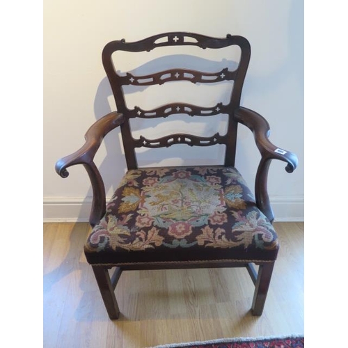 485 - A Georgian mahogany armchair with outswept arms on square legs - in sound condition with a nice pati... 