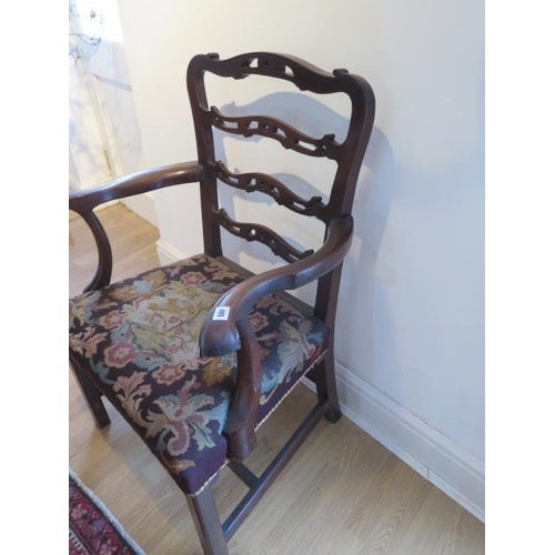 485 - A Georgian mahogany armchair with outswept arms on square legs - in sound condition with a nice pati... 