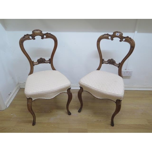 504 - A pair of reupholstered Victorian walnut balloon back dining chairs - Height 88cm