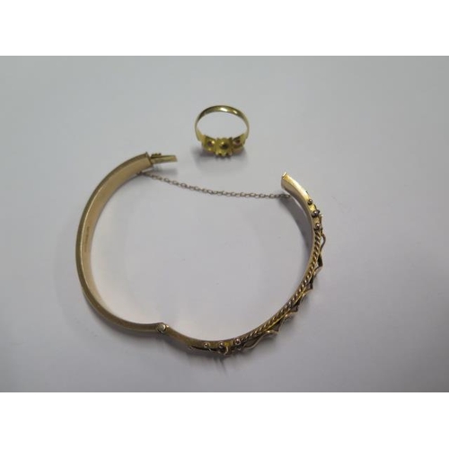 54 - A 9ct hallmarked yellow gold bangle - 6.5cm x 5.5cm external - approx weight 12 grams and a similar ... 