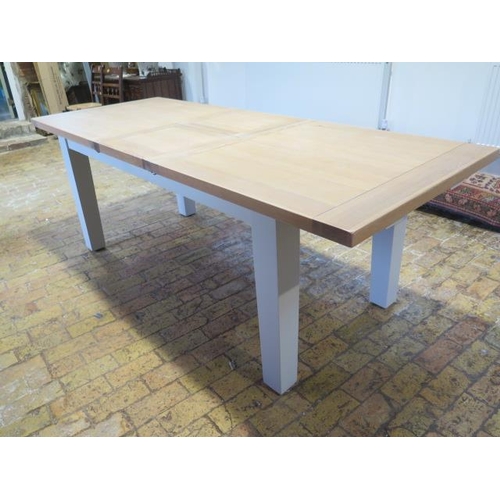 568 - A Neptune style dining table with two leaves which fold into the table - 230cm extended by 90cm but ... 