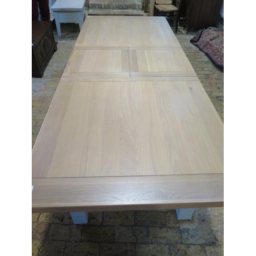 568 - A Neptune style dining table with two leaves which fold into the table - 230cm extended by 90cm but ... 