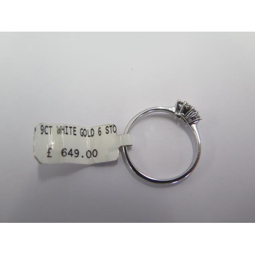 83 - A 9ct white gold six stone diamond ring size O - ex jewellers stock - as new condition - RRP £649