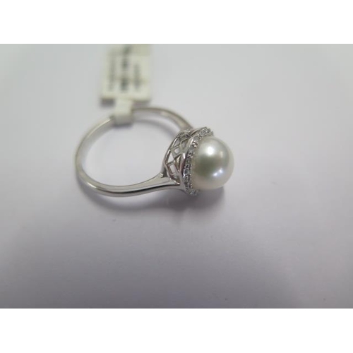 88 - A 9ct white gold diamond and pearl ring size N - approx weight 2.2 grams - ex jewellers stock - as n... 