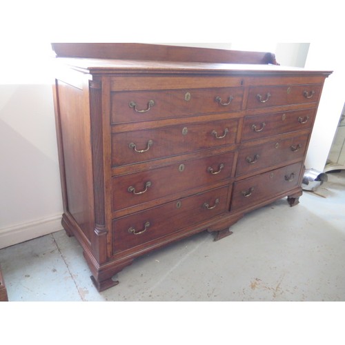 475 - An 18th century mahogany Lancashire mule chest with a lift up top enclosing storage with four faux d... 