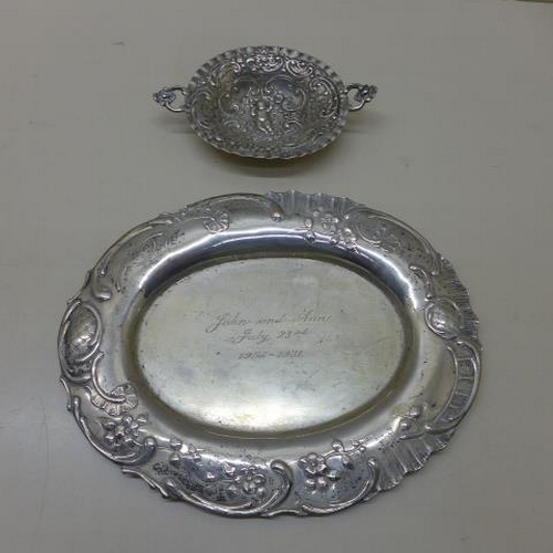 109 - A Continental embossed silver dish hallmarked London - Width 13cm - and a Continental silver present... 