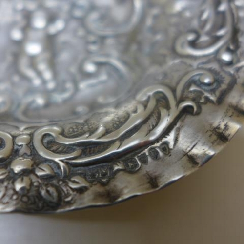 109 - A Continental embossed silver dish hallmarked London - Width 13cm - and a Continental silver present... 