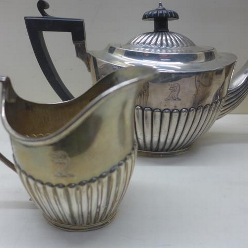 112 - A matched silver four piece coffee/tea set - teapot and milk jug London CSH 1895/96 with armorial cr... 