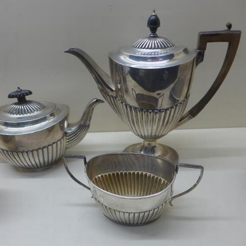 112 - A matched silver four piece coffee/tea set - teapot and milk jug London CSH 1895/96 with armorial cr... 