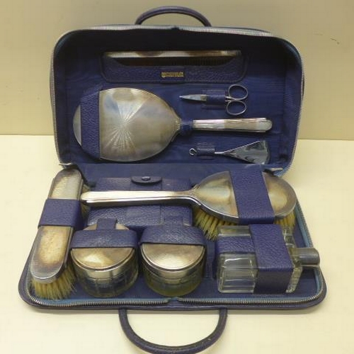 113 - A Mappin and Webb blue leather travel dressing case with silver back, two brushes, mirror, comb and ... 