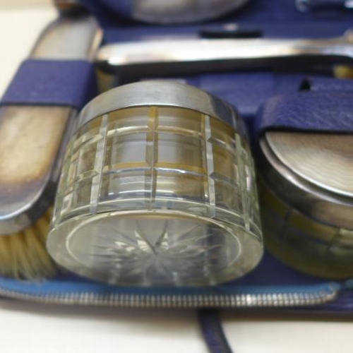 113 - A Mappin and Webb blue leather travel dressing case with silver back, two brushes, mirror, comb and ... 