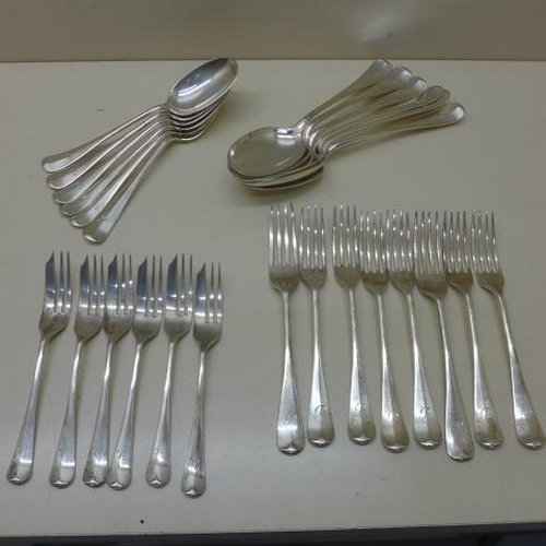 Two sets of six silver spoons, eight silver forks and six silver cake forks, all except two forks hallmarked Sheffield 1926/27 GH most initialled P, cake forks initialled C - total weight approx 36.2 troy oz