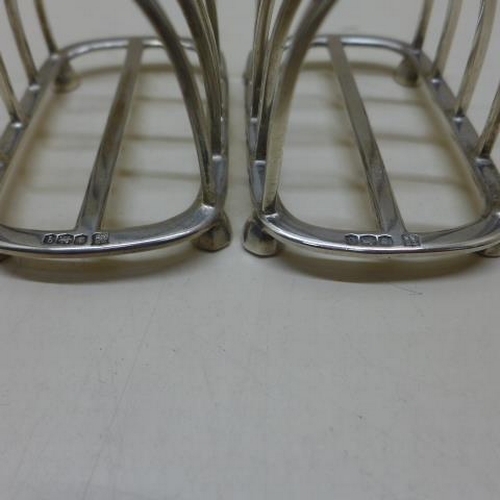 77 - A near pair of silver toast racks - Sheffield 1931/32 and 1933/34 TB & S - Length 9.5cm - total appr... 