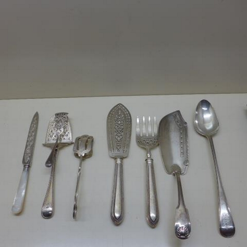 93 - A selection of seven silver and silver handle servers including asparagus tongs and a 30cm serving s... 