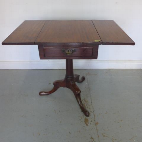 585 - A Georgian mahogany drop flap side table with two opposing drawers raised on a gun barrel base with ... 