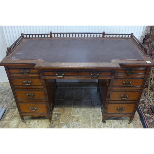 584 - A late 19th century arts and crafts mahogany breakfront desk with nine drawers - one drawer stamped ... 