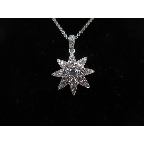 69 - An 18ct White Gold Diamond Encrusted Star Pendant by Luke and Stockley and Chain, approx. 0.75crts O... 