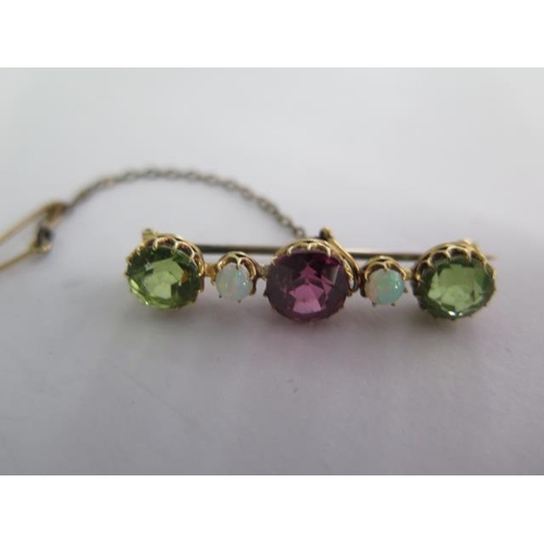 139 - A yellow gold amethyst, peridot and opal brooch - Length 35cm - weight approx 3.4 grams