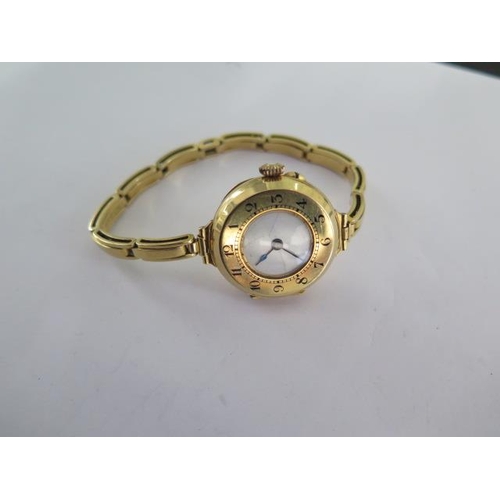 237B - An 18ct yellow gold manual wind ladies wristwatch on 18ct sprung strap - running - approx weight 27.... 