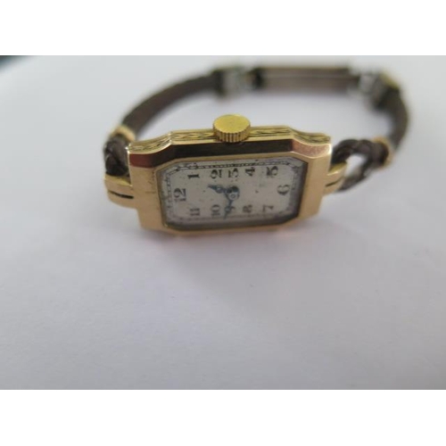 238B - A 9ct yellow gold manual wind ladies wristwatch on a leather strap - running - total weight approx 1... 