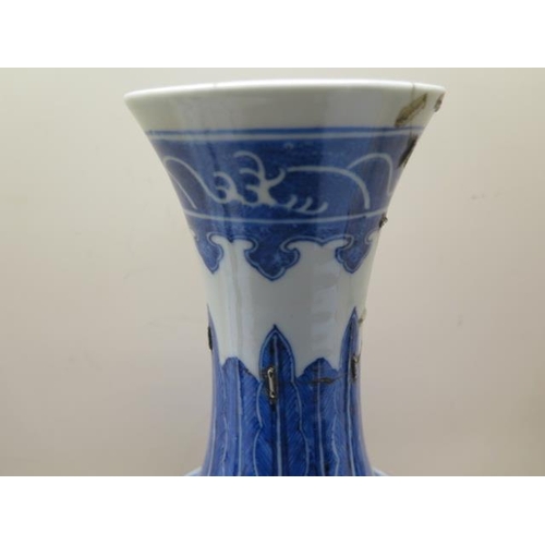 319 - An antique Chinese blue and white vase with old staple repairs to the neck - Height 40cm