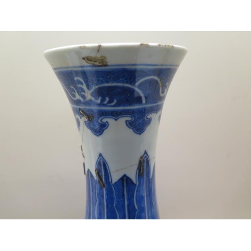 319 - An antique Chinese blue and white vase with old staple repairs to the neck - Height 40cm