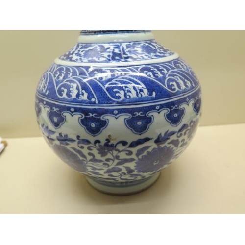 319 - An antique Chinese blue and white vase with old staple repairs to the neck - Height 40cm