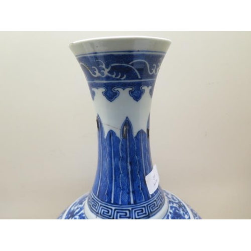 319 - An antique Chinese blue and white vase with old staple repairs to the neck - Height 40cm